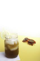 iced tea and sunglasses on a table 