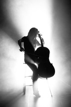 woman playing a cello on stage