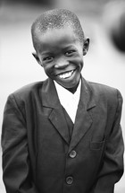 Smiling boy wearing a suit.