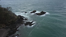 Aerial view of jagged rocks in the middle of the Pacific ocean