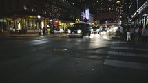 cars on a downtown street at night