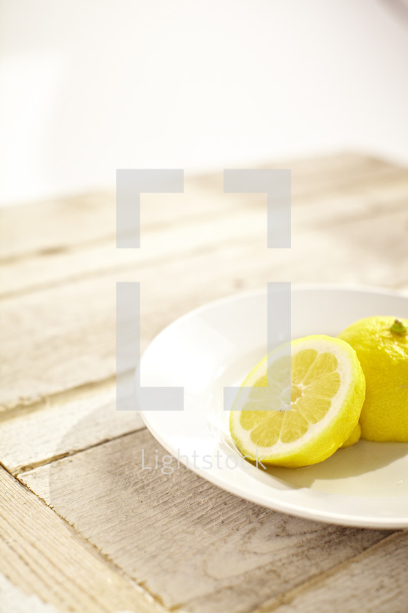 A lemon sliced in half on a plate