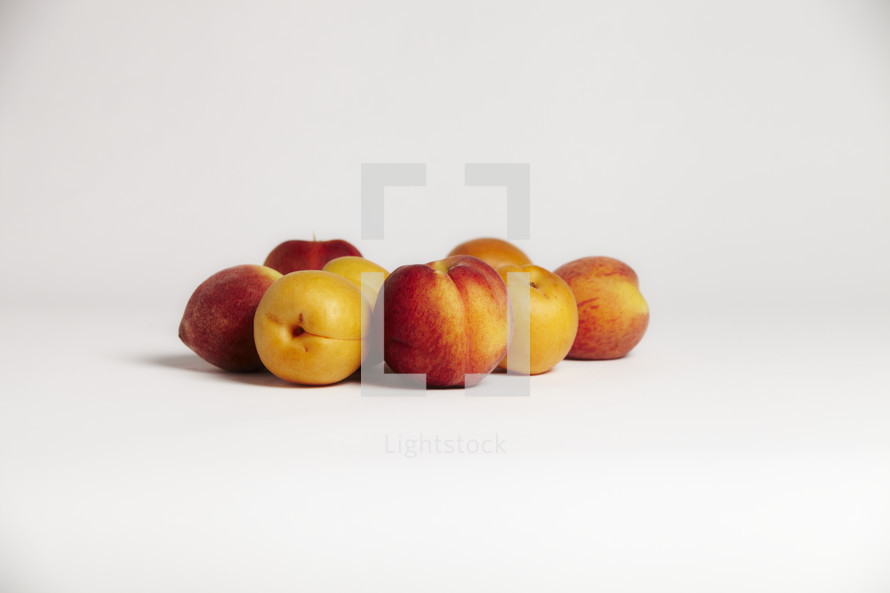 a group of peaches on seamless white