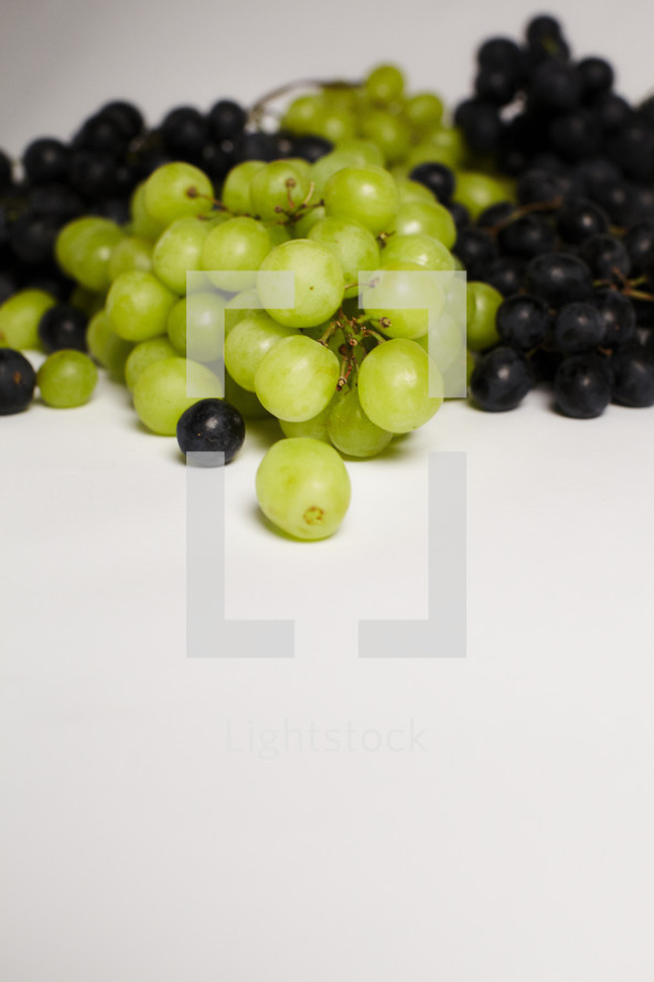 Bunches of green & purple grapes isolated on white