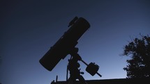 A telescope pointing to an astronomical object in the night sky