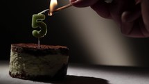 Candle five in tiramisu cake