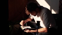 a man sitting reading 