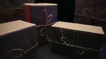 Gift boxes wrapped in craft rustic paper. Recycle packaging, macro holiday 