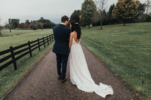 bride and groom and country road and fence line 