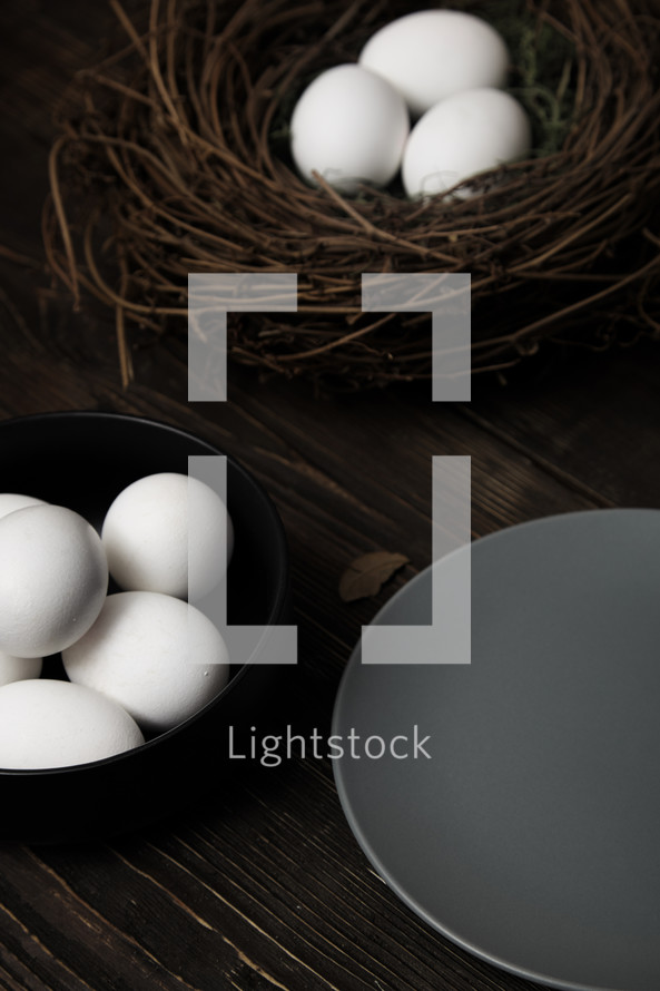Easter eggs and bird nest on a rustic wooden table