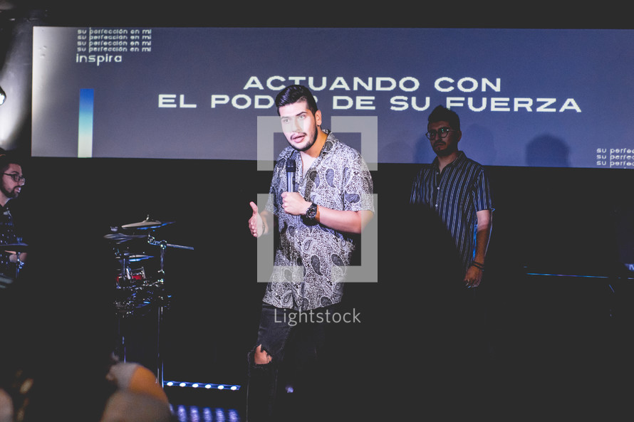 worship leader on stage with a microphone 