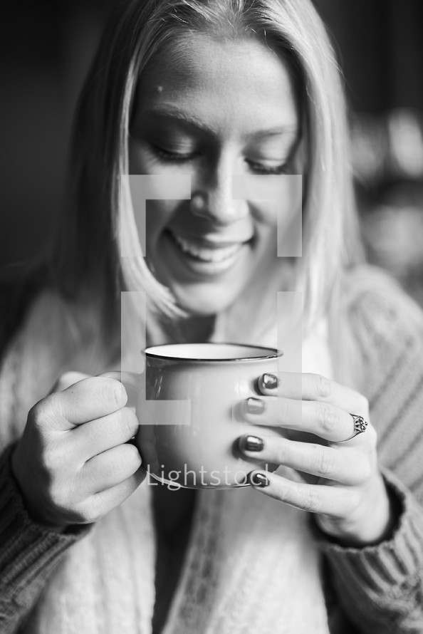 woman drinking from a coffee cup 