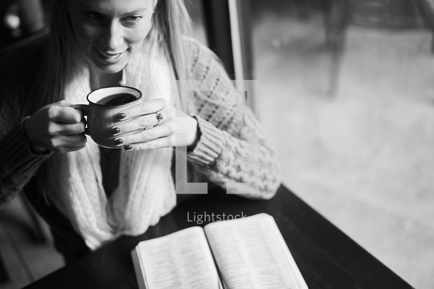 a woman reading a Bible and drinking coffee