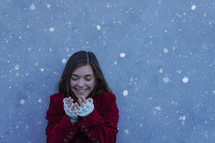 a teen girl catching snowflakes 