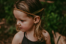 toddler girl with a leaf in her headband 