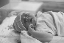 a newborn baby girl in a hospital bed 