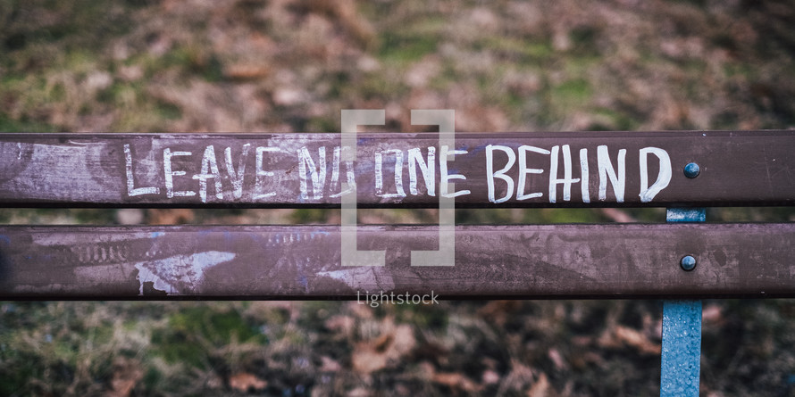Leave no one behind written on a bench 