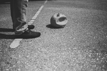 feet standing next to a deflated ball