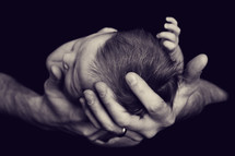 newborn baby in father's hands 