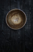 a wood bowl on wood boards 