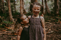 little girls with mud on their faces 