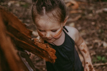 toddler girl with mud on her face 