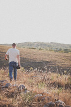 man walking in a field 