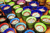 colorful stacked bowls at a market 