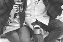 a couple sitting together drinking coffee 