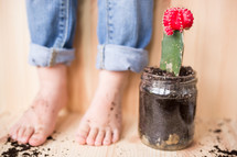 dirt feet and a mason jar with a cactus 