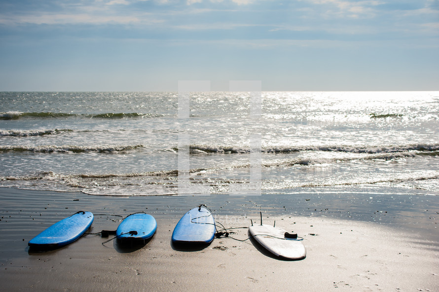 surfboards on a beach 