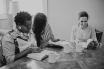 Women's Bible study group reading Bibles 