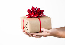 A person holding out a gift on a white background