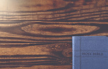 Background with a Bible on a Rustic Wooden Table