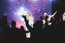 hands raised at a worship service 