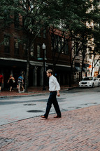 a man walking on a downtown sidewalk 