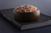 pink Himalayan salt on a Bible 
