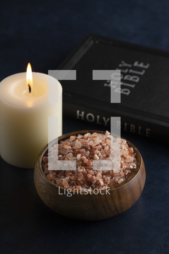 candle and bowl of pink Himalayan salt with Bible 