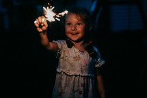 child playing with sparklers on the 4th of July