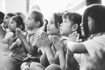 girl children praying together 
