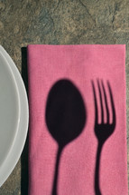 Abstract Plate With Shadow Cutlery on Stone Table