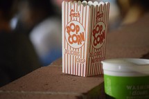 popcorn and a drink cup at a ballgame 