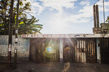 man walking in front of a boarded up store front in Haiti 