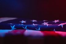 American flag under red and blue light