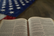 Open Bible next to the American flag