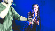 people singing on stage during a worship service 