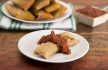 Homemade Wrapped Tamales Isolated on a Wood Background