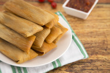 Homemade Wrapped Tamales Isolated on a Wood Background