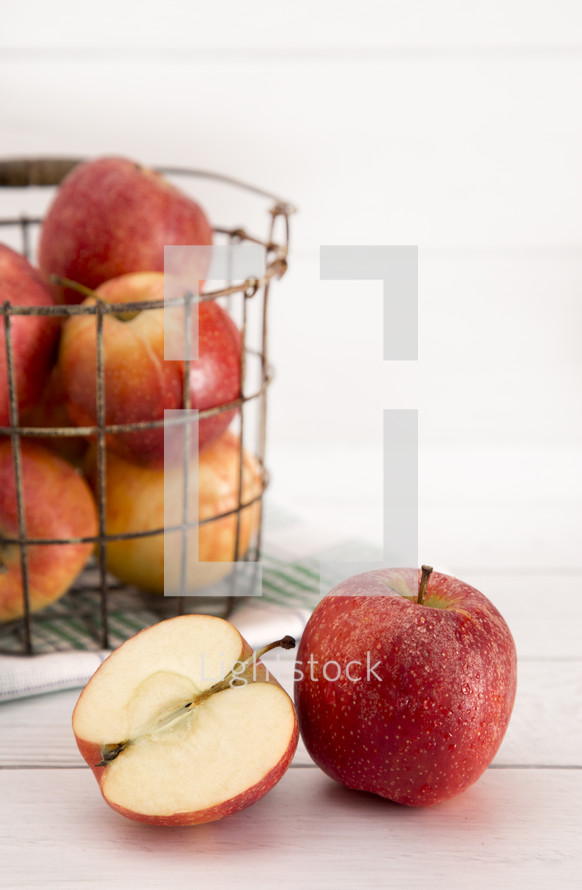 wire basket with apples 