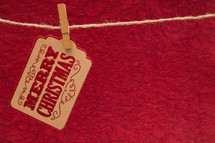 Merry Christmas tag hanging by clothespins 